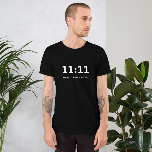 11:11 angel number design, the number set in plain white type above Notice, Align, Receive, on a black unisex t-shirt, front view