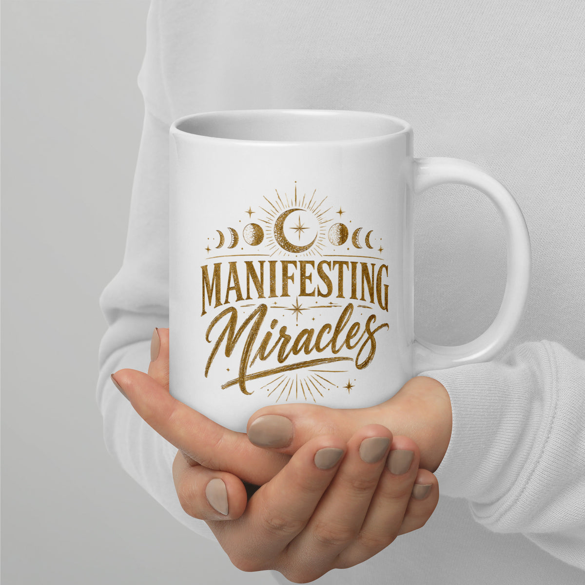 Manifesting Miracles design with moon phases in antique gold, on a white glossy mug, 20 oz, handle on the right