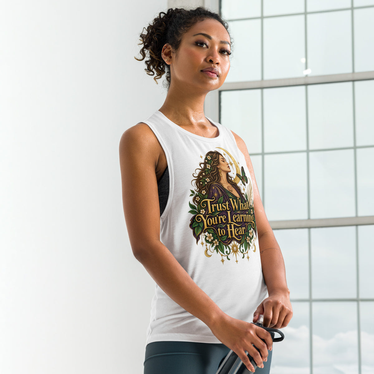 Trust What You're Learning to Hear design, on a white ladies' muscle tank, front view