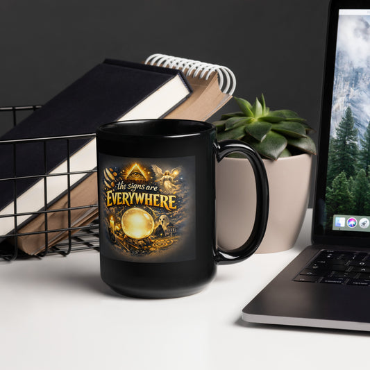 The Signs Are Everywhere design, an all-seeing eye, an angel, a crystal ball, a ghost and a 111 road sign in gold, on a black glossy mug, 15 oz, handle on the right