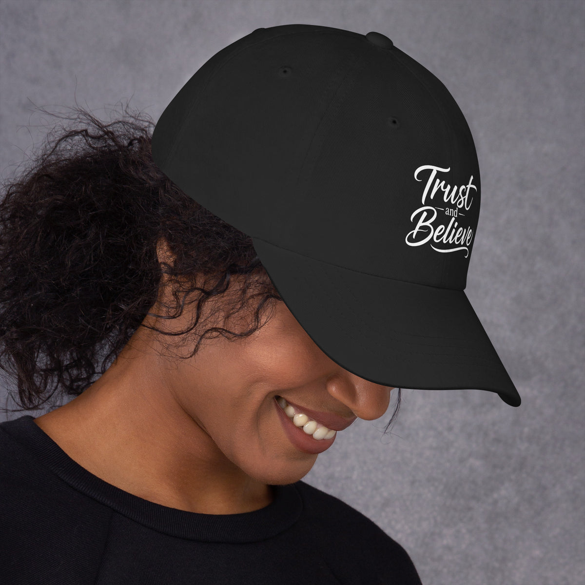 Trust and Believe design, on a black dad hat, right side view