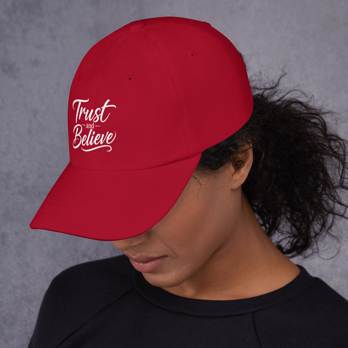 Trust and Believe design, on a cranberry dad hat, left side view