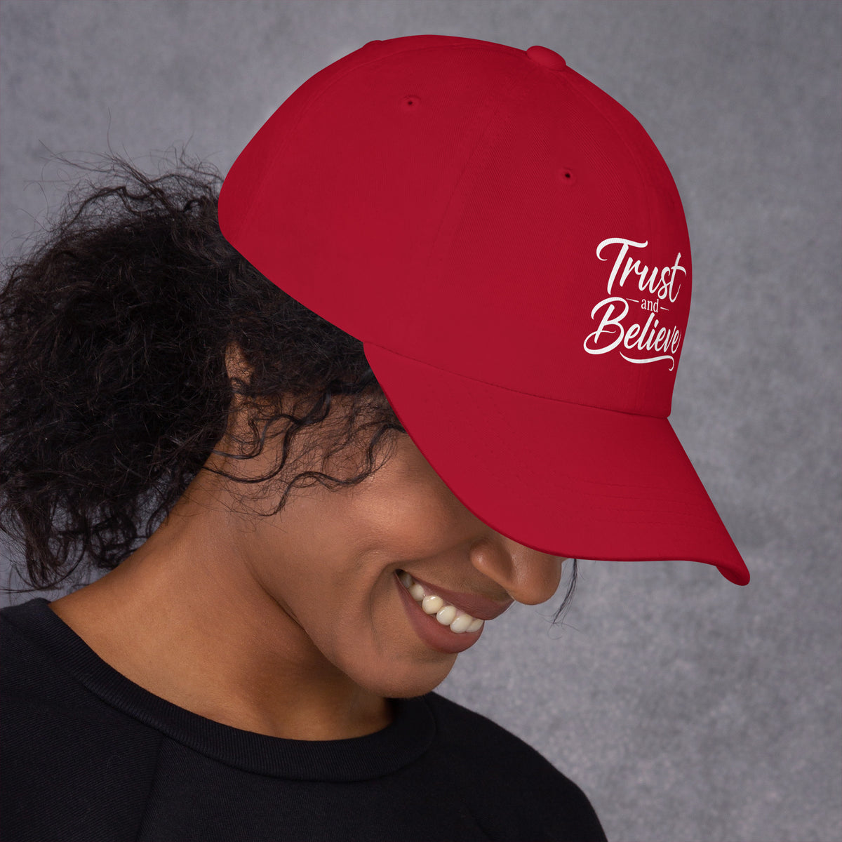 Trust and Believe design, on a cranberry dad hat, right side view