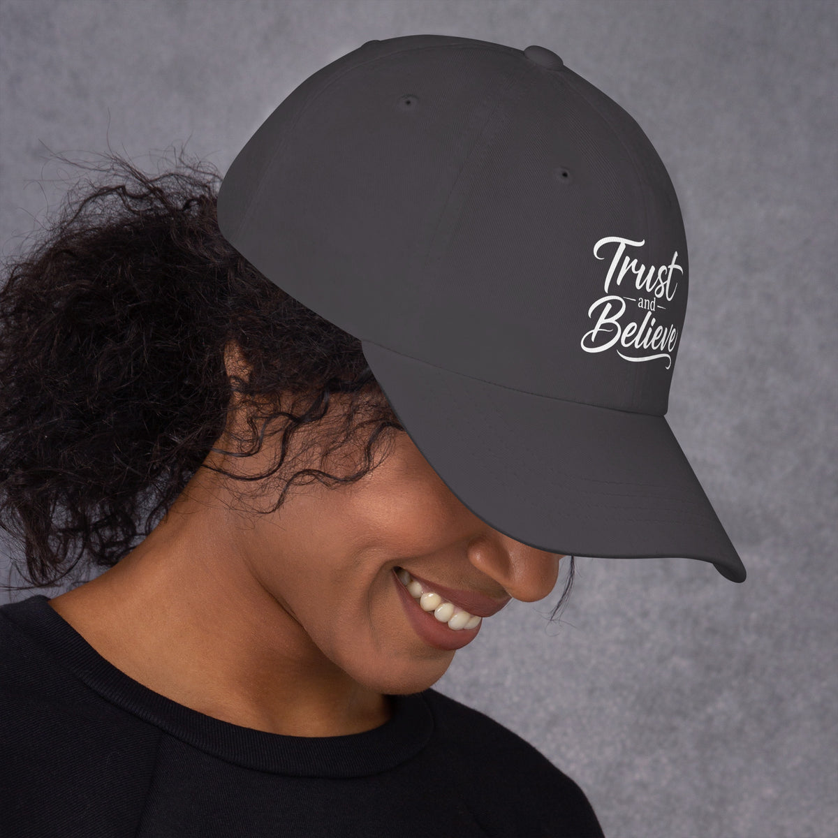 Trust and Believe design, on a dark grey dad hat, right side view