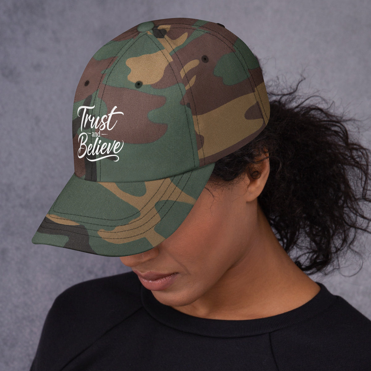 Trust and Believe design, on a green camo dad hat, left side view