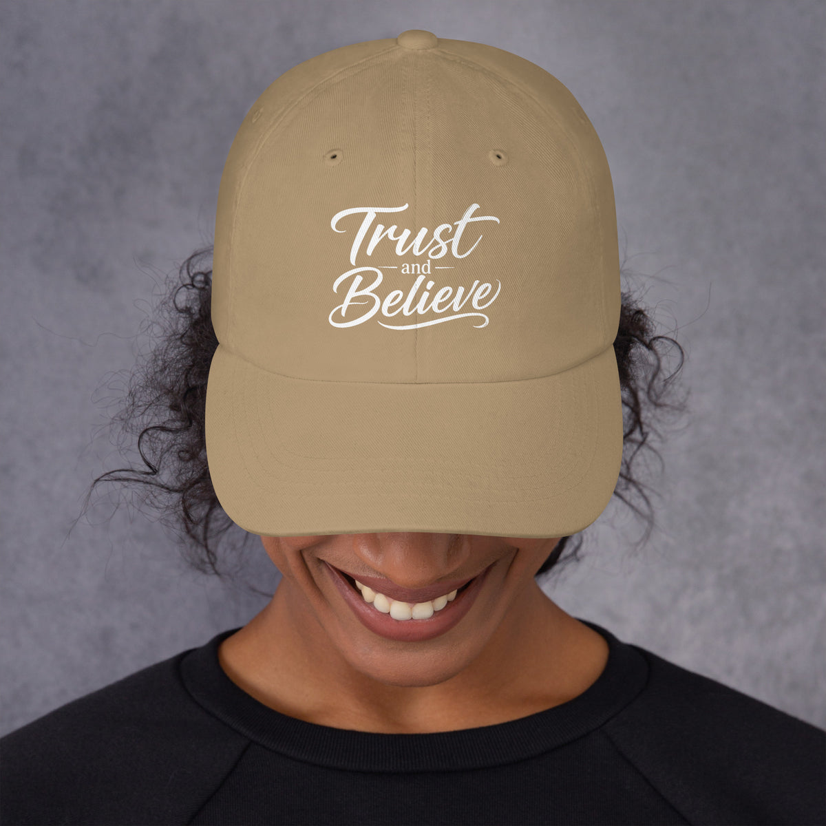 Trust and Believe design, on a khaki dad hat, front view