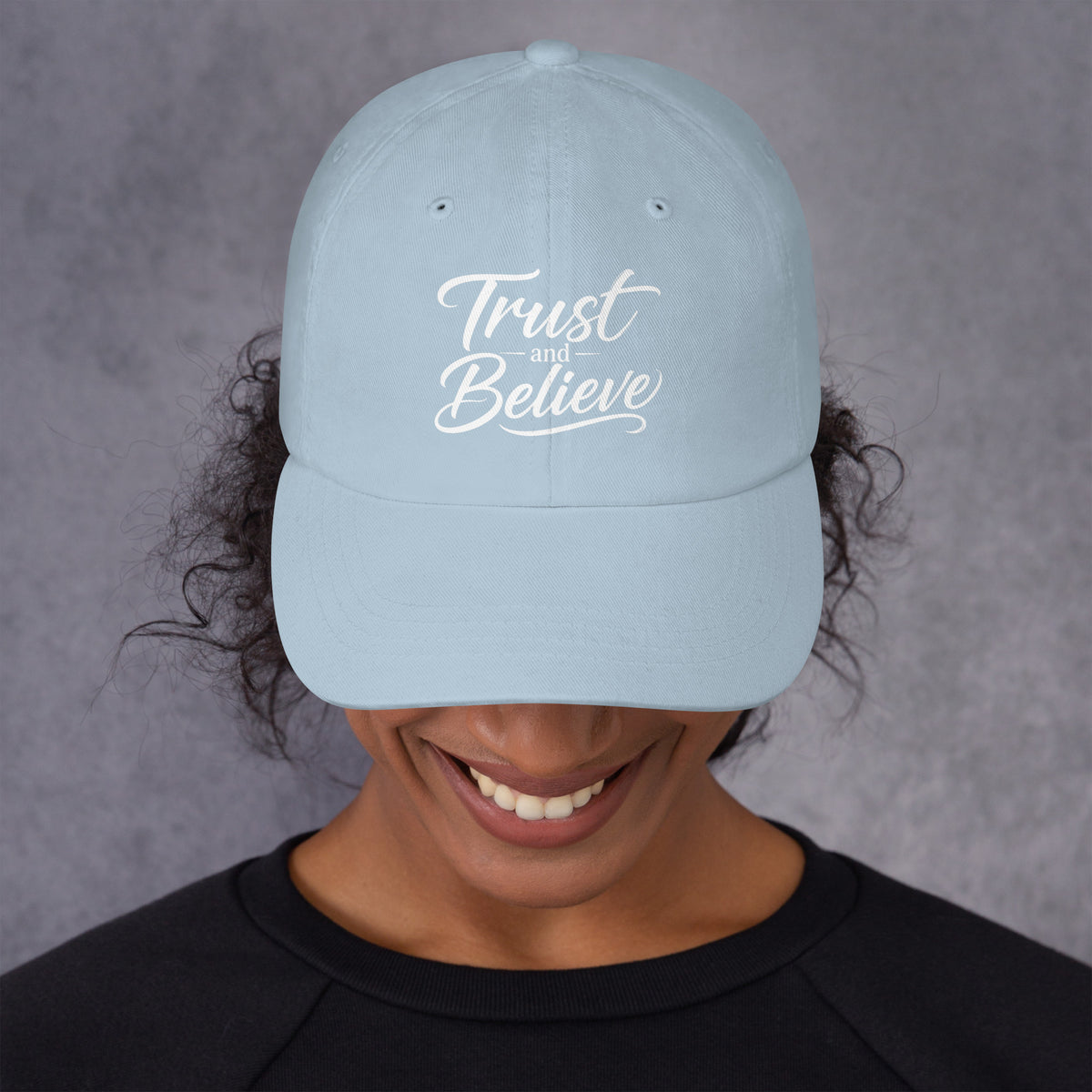 Trust and Believe design, on a light blue dad hat, front view