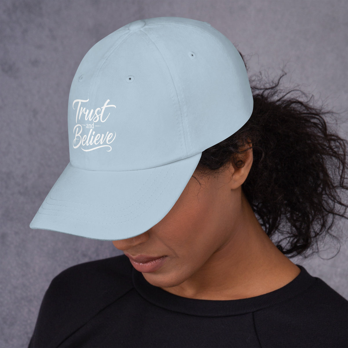 Trust and Believe design, on a light blue dad hat, left side view