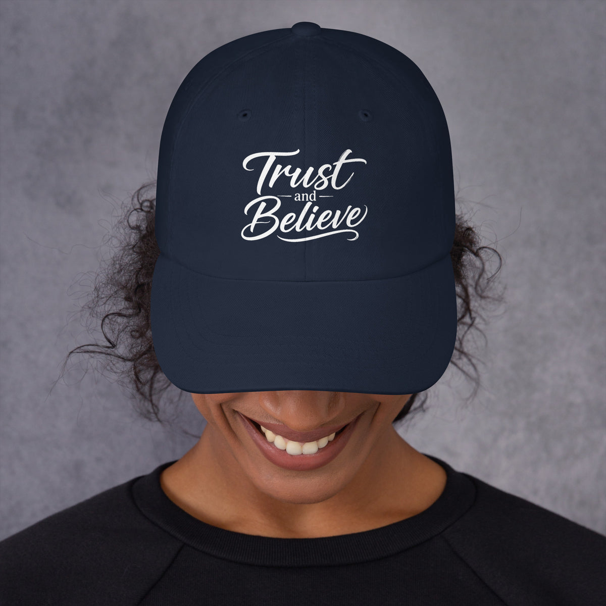 Trust and Believe design, on a navy dad hat, front view
