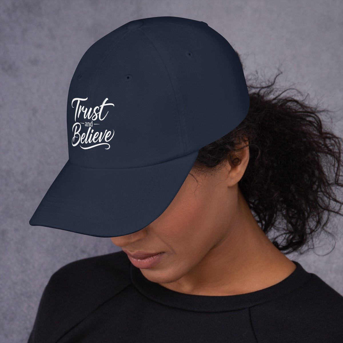 Trust and Believe design, on a navy dad hat, left side view