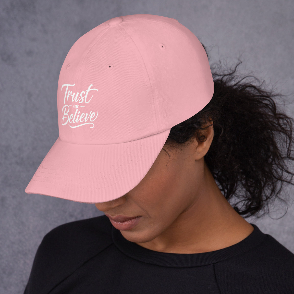 Trust and Believe design, on a pink dad hat, left side view