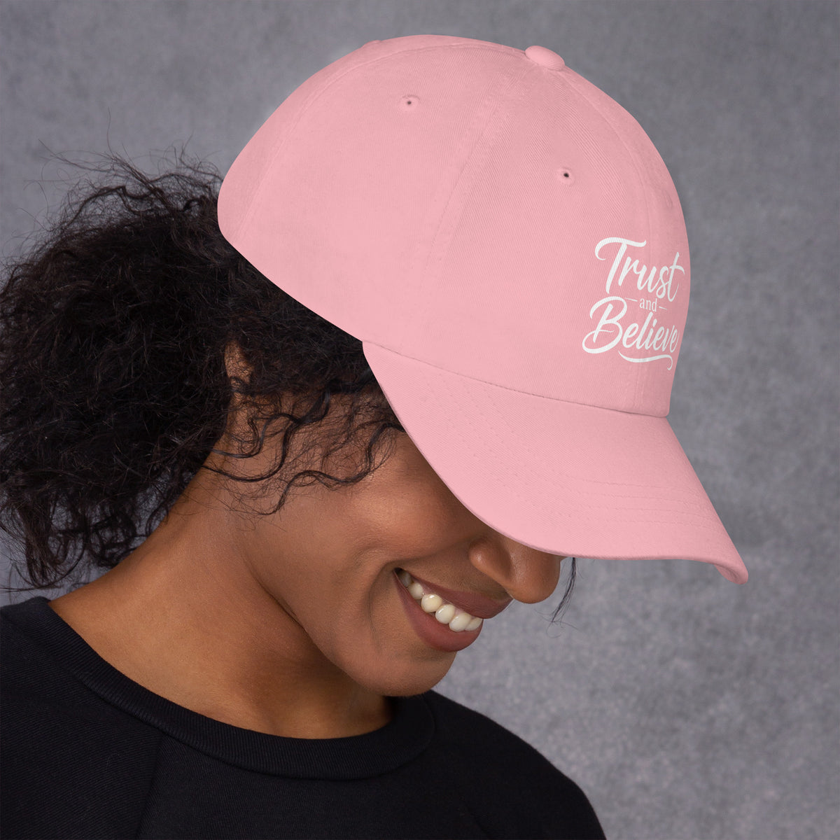 Trust and Believe design, on a pink dad hat, right side view