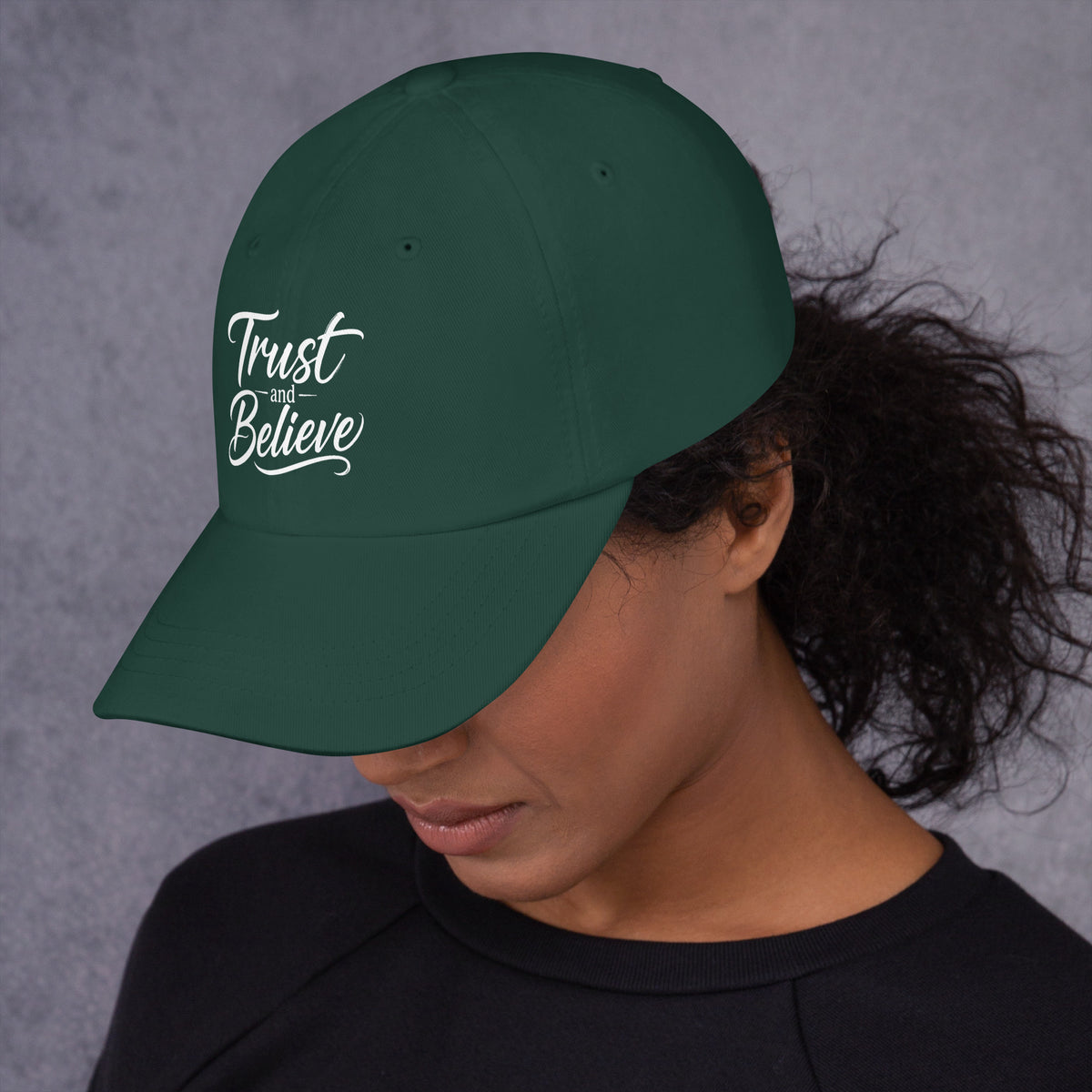 Trust and Believe design, on a spruce dad hat, left side view
