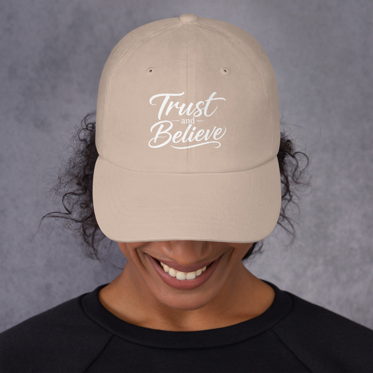 Trust and Believe design, on a stone dad hat, front view