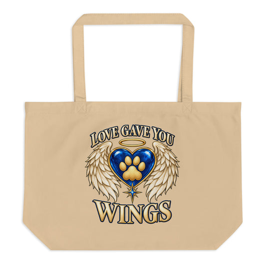 Love Gave You Wings design, a blue gem heart with a gold halo, cream angel wings and a gold cat paw print at its center, under gold lettering, on an oyster large organic tote bag, front view