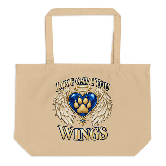 Love Gave You Wings design, a blue gem heart with a gold halo, cream angel wings and a gold dog paw print at its center, under gold lettering, on an oyster large organic tote bag, front view