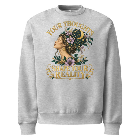Your Thoughts Shape Your Reality oversized heavyweight sweatshirt in athletic heather, front. Gold lettering above a woman's profile with stars and lavender.