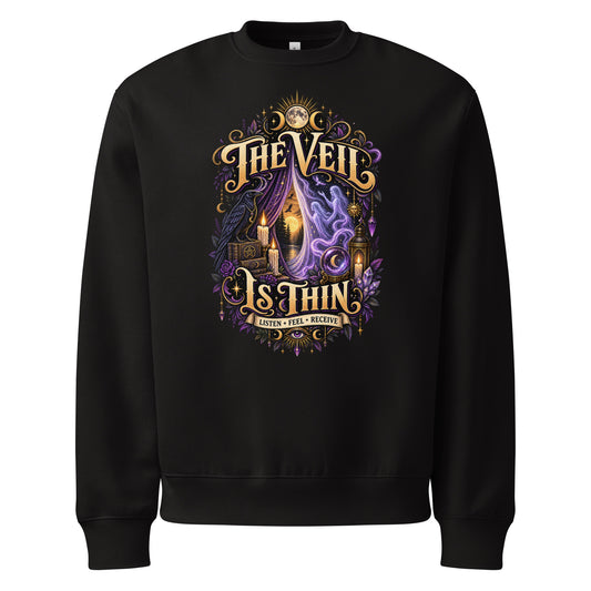 The Veil Is Thin whimsigoth design, a raven, candles and spirits rising through a parted veil, on a black oversized heavyweight sweatshirt, front view
