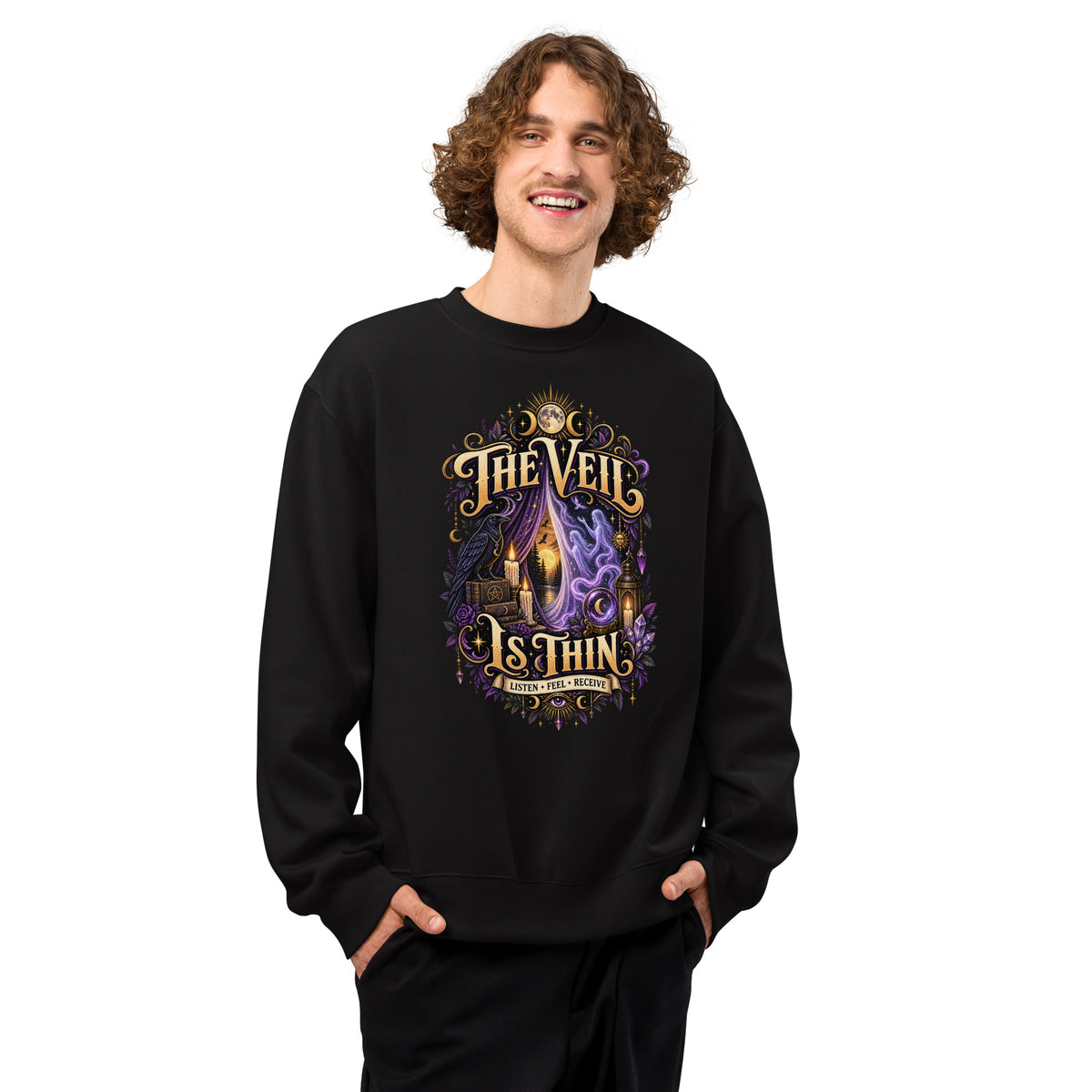 The Veil Is Thin whimsigoth design, a raven, candles and spirits rising through a parted veil, on a black oversized heavyweight sweatshirt, worn by a model, front view