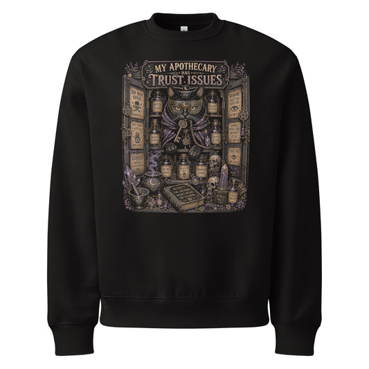 My Apothecary Has Trust Issues, a witchy black cat and a cabinet of potion bottles, on a black oversized heavyweight sweatshirt, front view