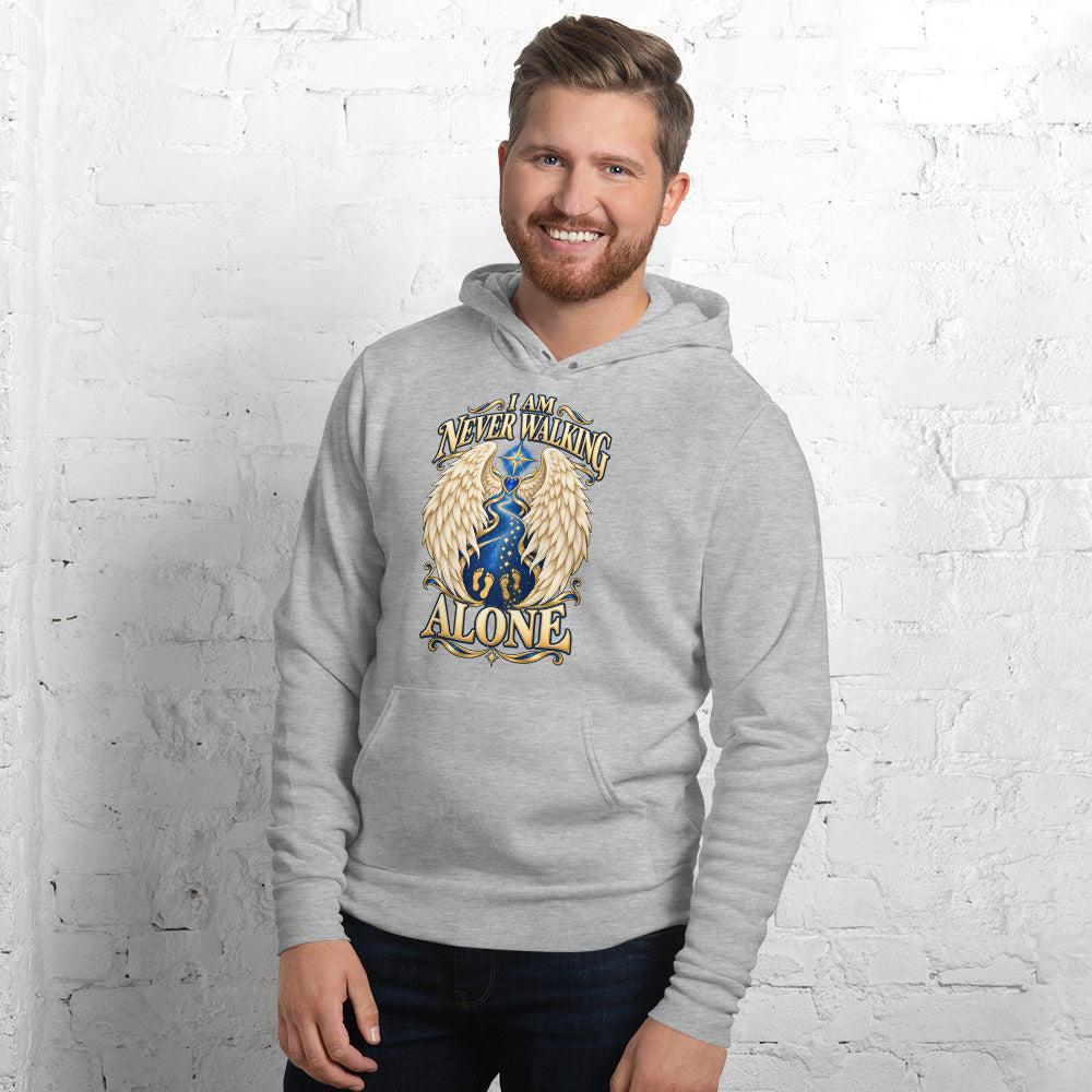 I Am Never Walking Alone design, cream angel wings framing a starry path with two sets of gold footprints and a blue gem heart, on an athletic heather pullover hoodie worn by a model, front view