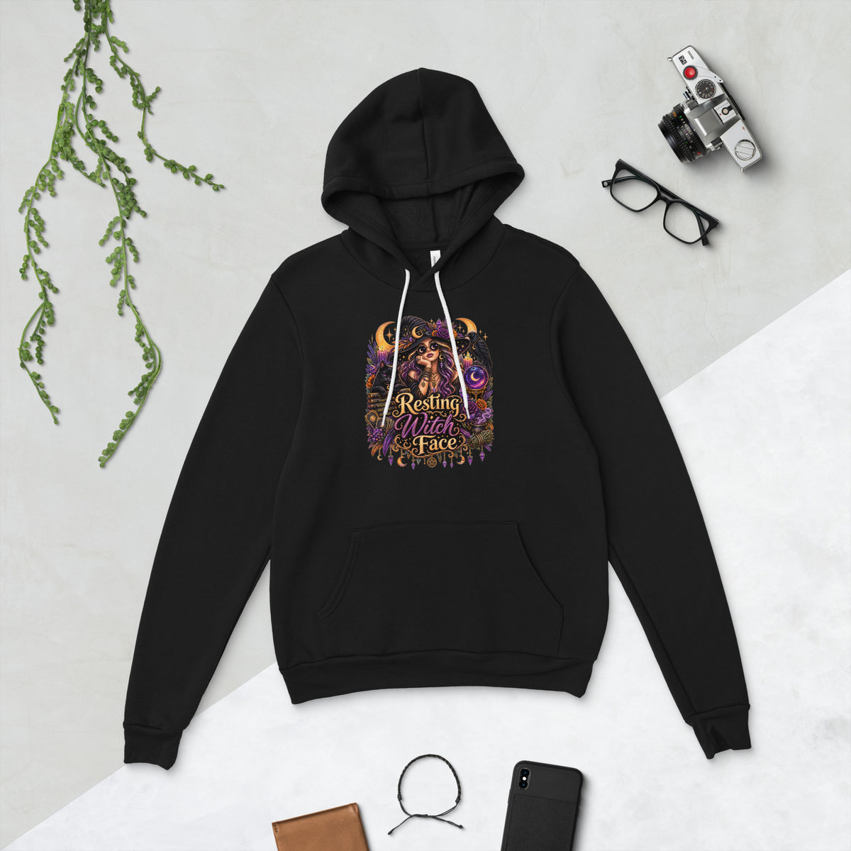 Resting Witch Face whimsigoth design, a witch in round sunglasses with her black cat and a raven, on a black unisex pullover hoodie, front view