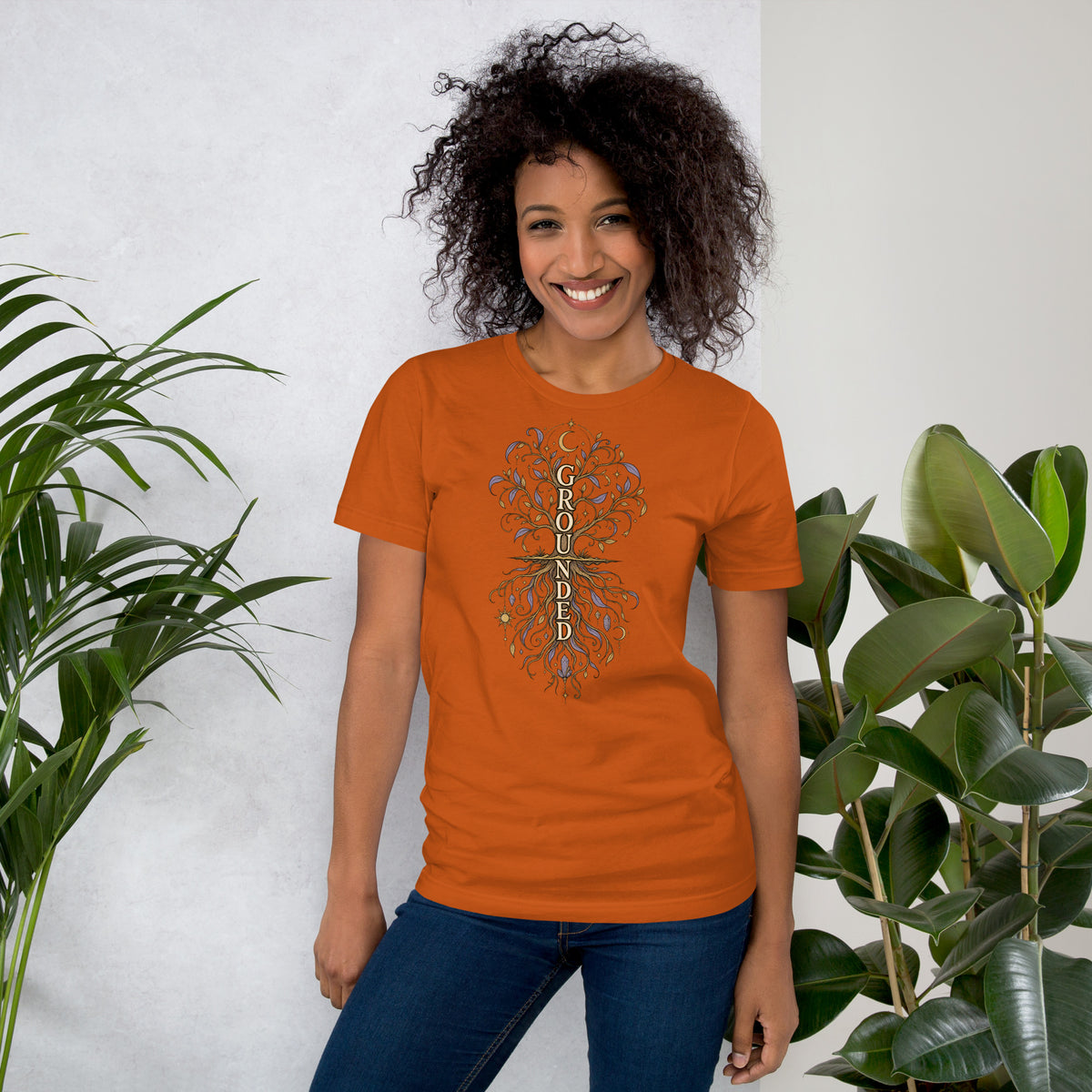 Own Your Grounded Energy design, an ornate tree with gold leaves and crystals in its roots, on an autumn unisex t-shirt, front view