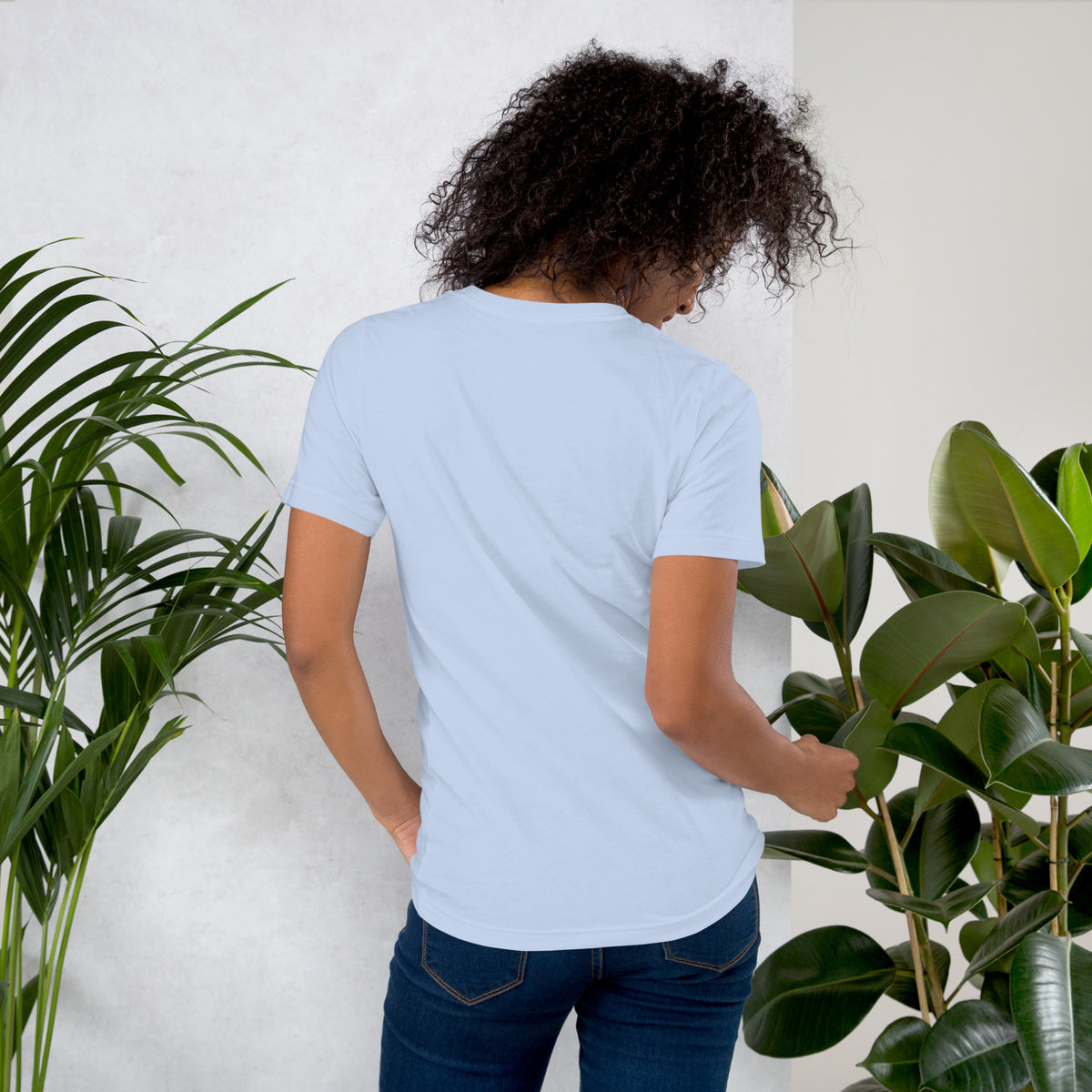 Own Your Grounded Energy design, an ornate tree with gold leaves and crystals in its roots, on a baby blue unisex t-shirt, back view