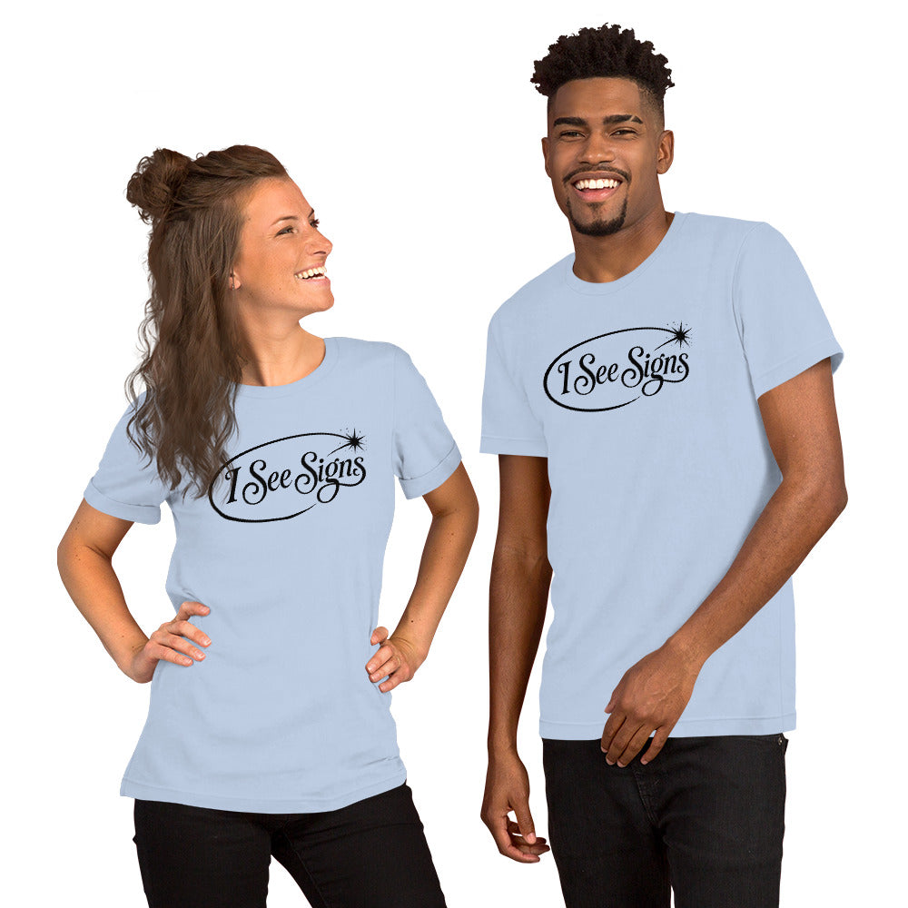 I See Signs design, the words set in black script inside a thin oval with a four-pointed star, on a baby blue unisex t-shirt, front view