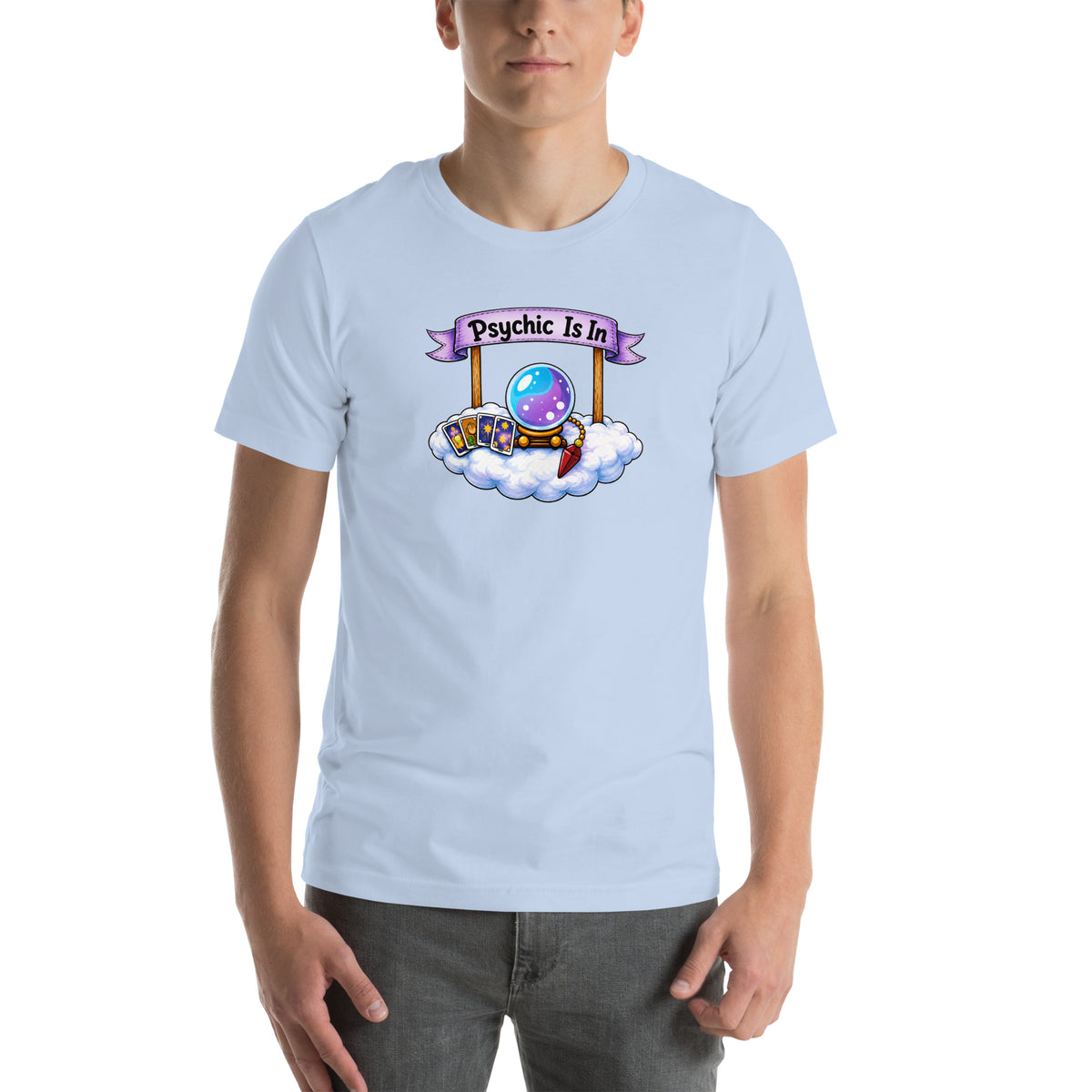 Psychic Is In design, playful floating clouds beneath a banner that reads Psychic Is Open for Business, on a baby blue unisex t-shirt, front view