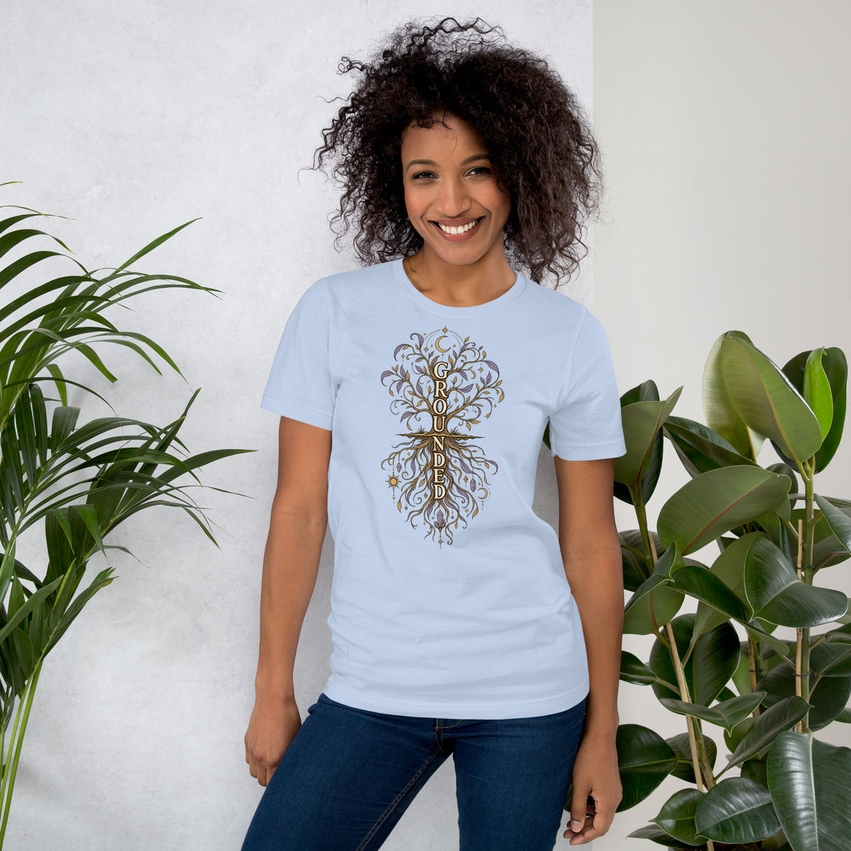 Own Your Grounded Energy design, an ornate tree with gold leaves and crystals in its roots, on a baby blue unisex t-shirt, front view