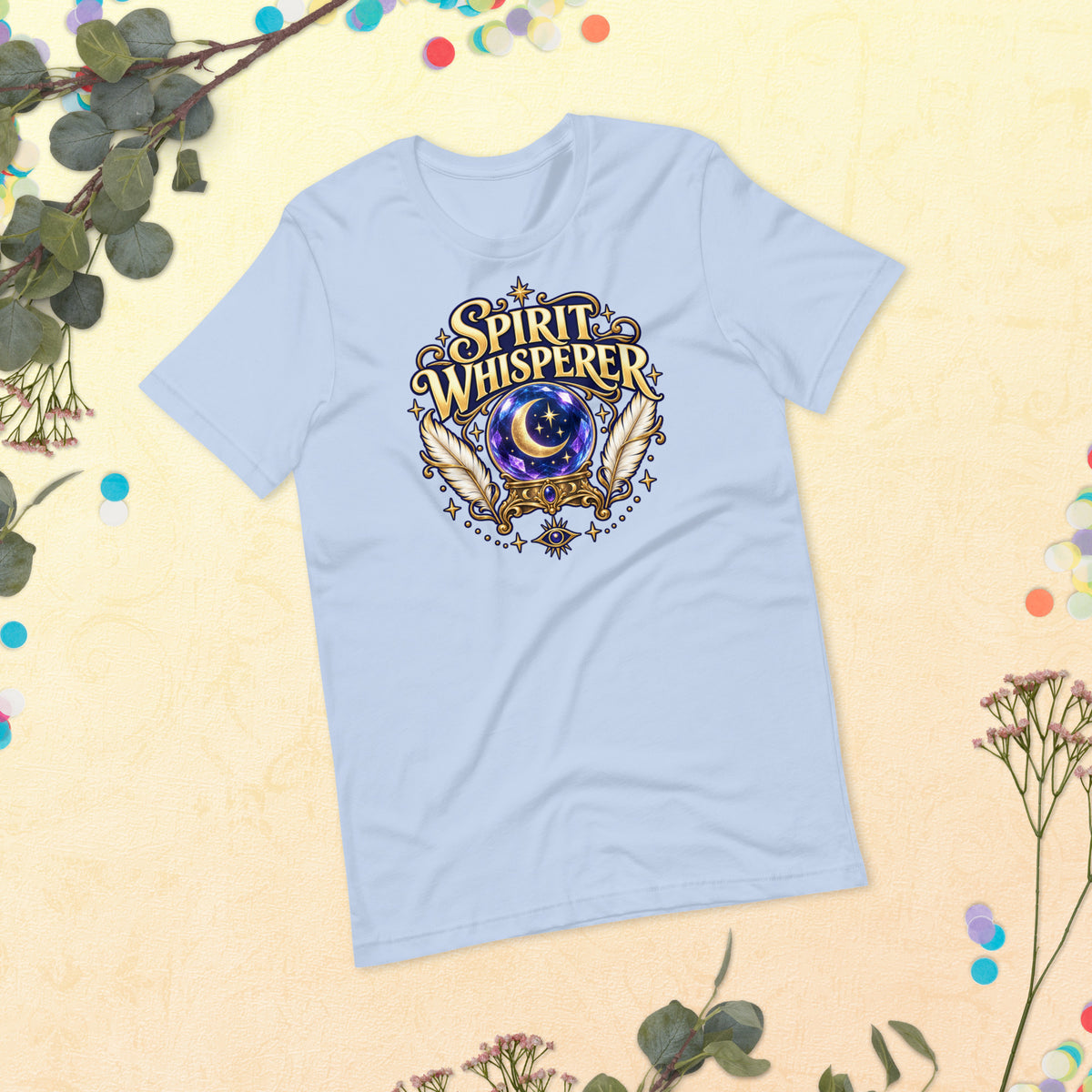 Spirit Whisperer unisex t-shirt in baby blue, front, laid flat. A crystal ball and feathers in a gold roundel.