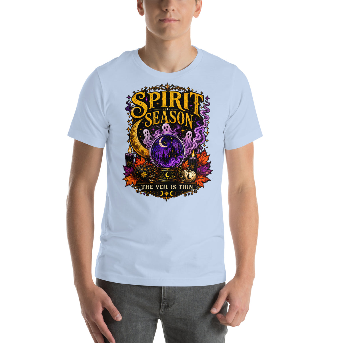 Spirit Season The Veil Is Thin design, three ghosts around a crystal ball, on a baby blue unisex t-shirt, front view