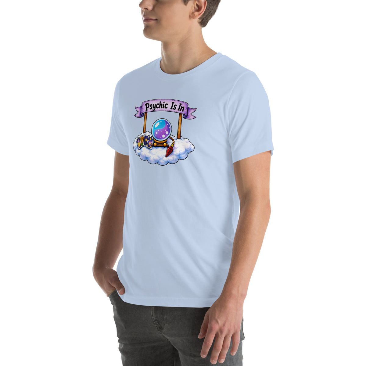 Psychic Is In design, playful floating clouds beneath a banner that reads Psychic Is Open for Business, on a baby blue unisex t-shirt, angled left front view