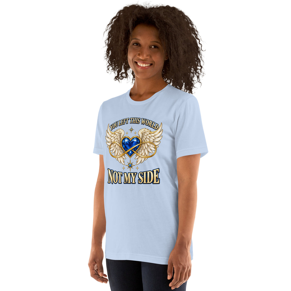 You Left This World Not My Side design, a blue gem heart with cream angel wings and a gold infinity ribbon under gold lettering, on a baby blue unisex t-shirt worn by a model, angled to the left