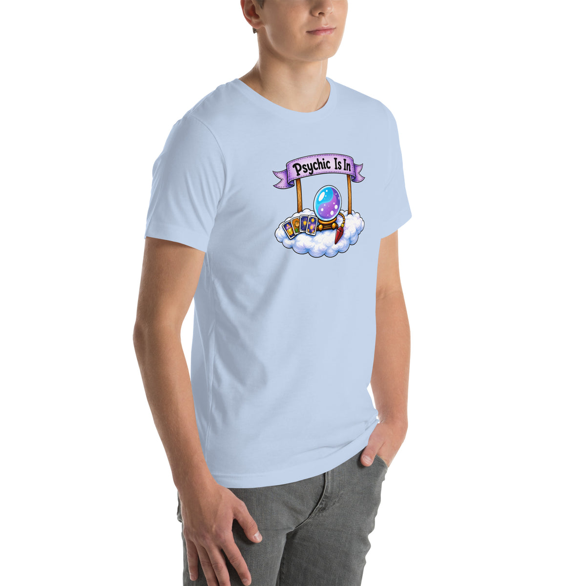 Psychic Is In design, playful floating clouds beneath a banner that reads Psychic Is Open for Business, on a baby blue unisex t-shirt, angled right front view