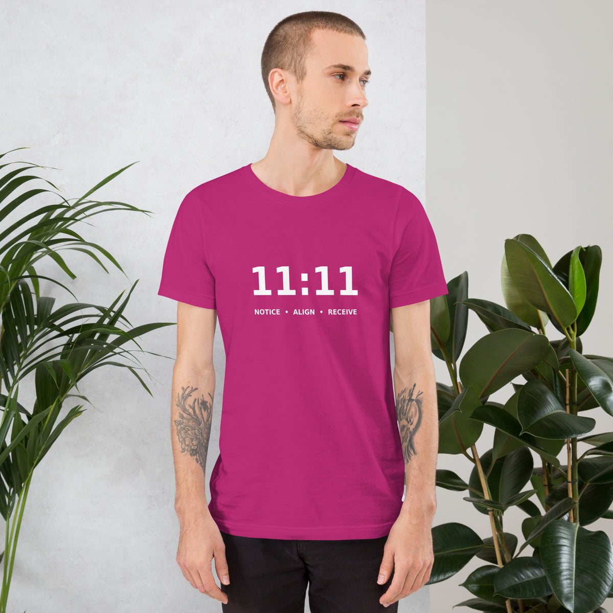 11:11 angel number design, the number set in plain white type above Notice, Align, Receive, on a berry unisex t-shirt, front view