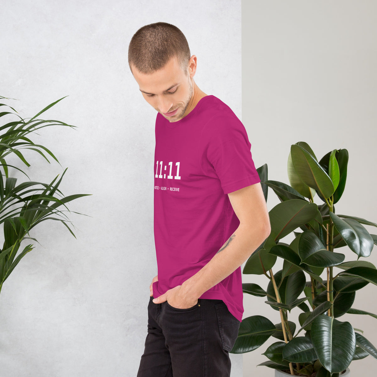 11:11 angel number design, the number set in plain white type above Notice, Align, Receive, on a berry unisex t-shirt, left side view
