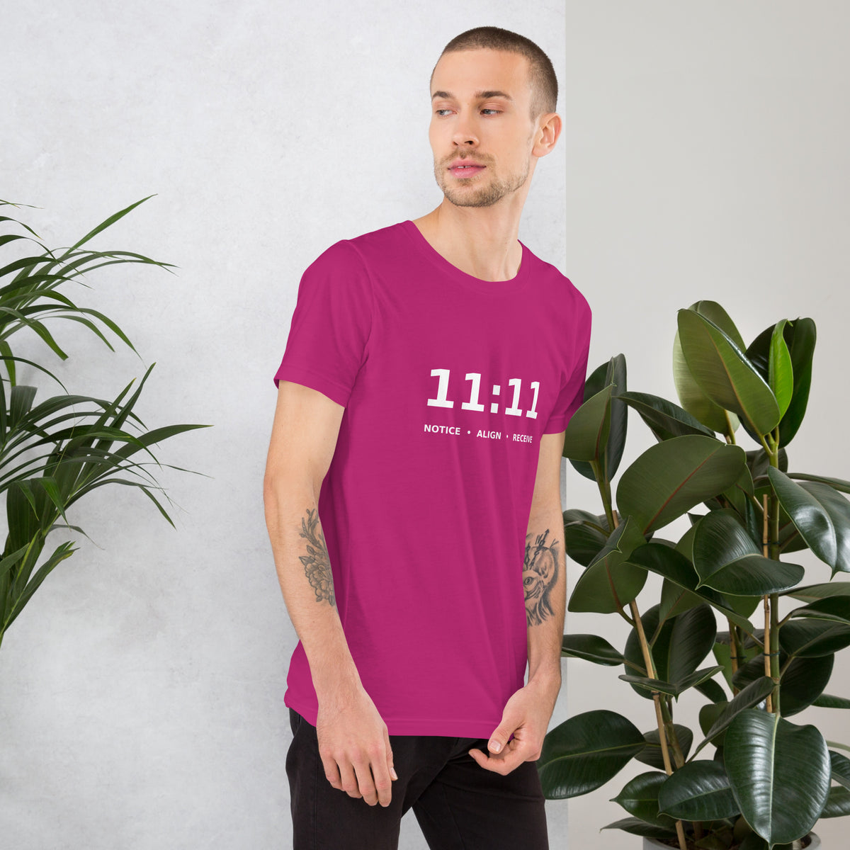 11:11 angel number design, the number set in plain white type above Notice, Align, Receive, on a berry unisex t-shirt, right side view