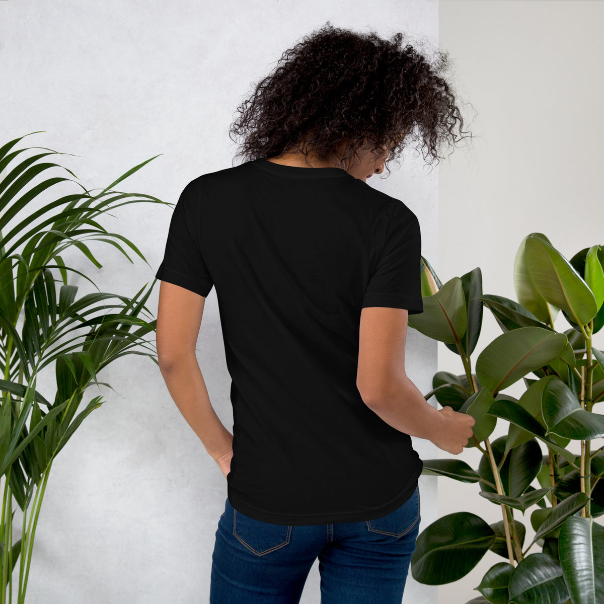 My Apothecary Has Trust Issues, a witchy black cat and a cabinet of potion bottles, on a black unisex t-shirt, back view