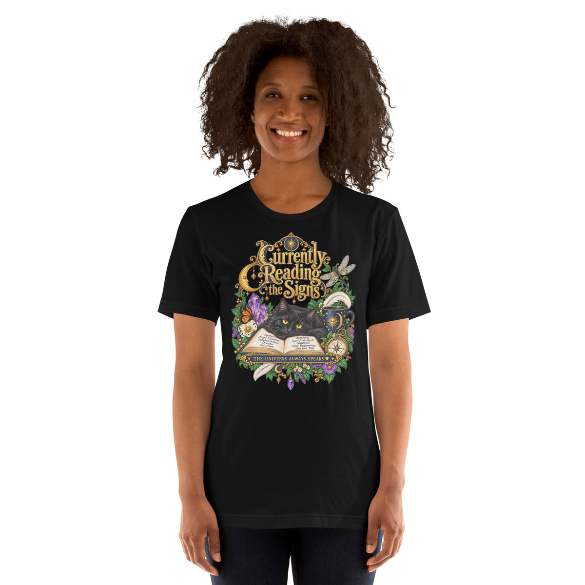 Currently Reading The Signs dark academia design, two black cats asleep over an open book beneath a crescent moon, on a black unisex t-shirt, front view