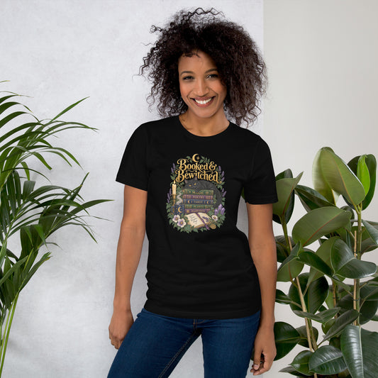 Booked and Bewitched dark academia design, a black cat asleep on a stack of spellbooks, on a black unisex t-shirt, front view