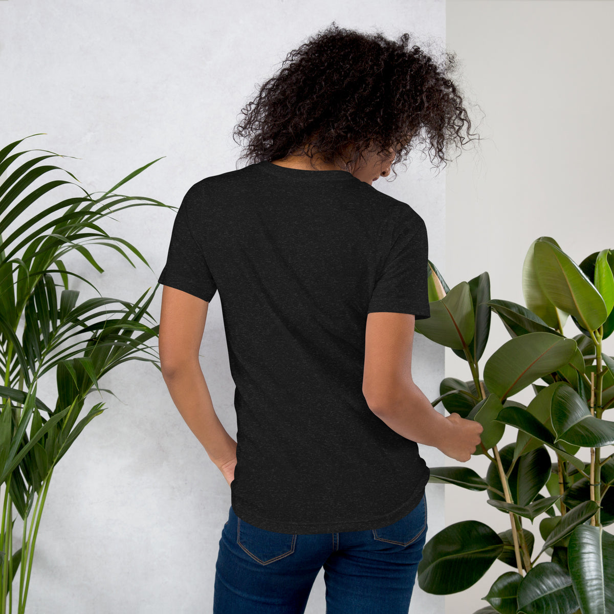 My Apothecary Has Trust Issues, a witchy black cat and a cabinet of potion bottles, on a black heather unisex t-shirt, back view
