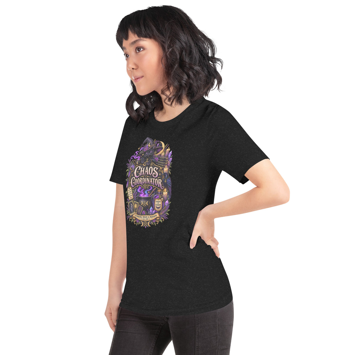 Chaos Coordinator whimsigoth design, a witchy black cat in a pointed hat, on a black heather unisex t-shirt, left front view