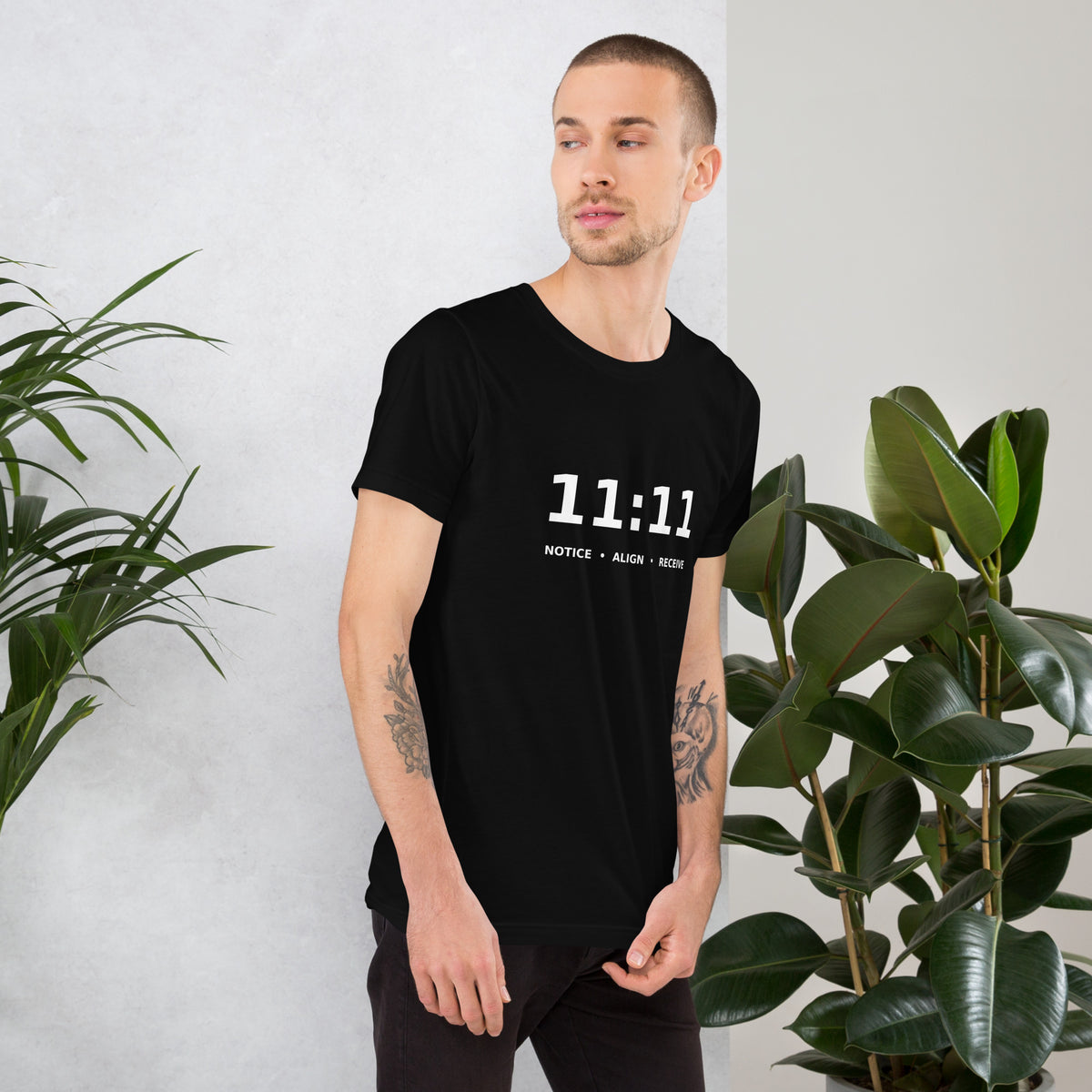 11:11 angel number design, the number set in plain white type above Notice, Align, Receive, on a black unisex t-shirt, right side view