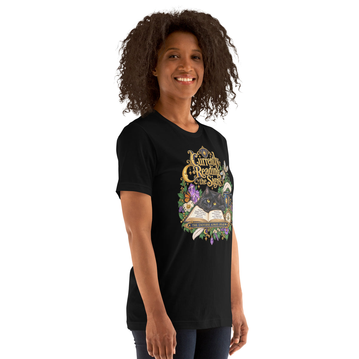 Currently Reading The Signs dark academia design, two black cats asleep over an open book beneath a crescent moon, on a black unisex t-shirt, right front view