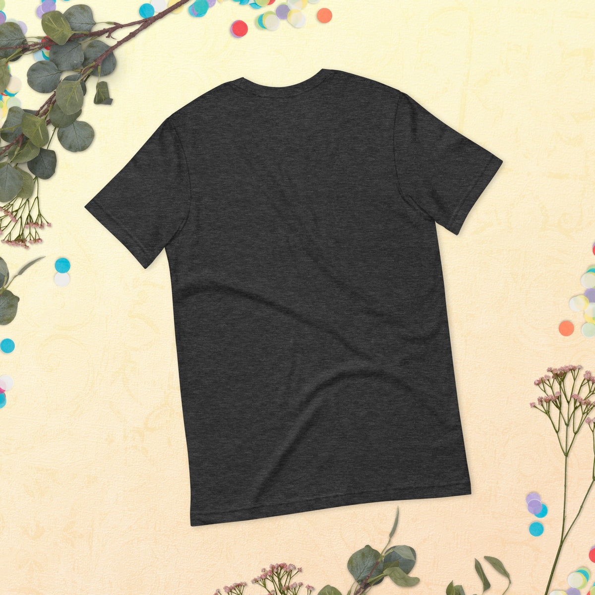 Love Gave You Wings design, on a dark grey heather unisex t-shirt, plain back view with no design, styled flat lay on a cream backdrop