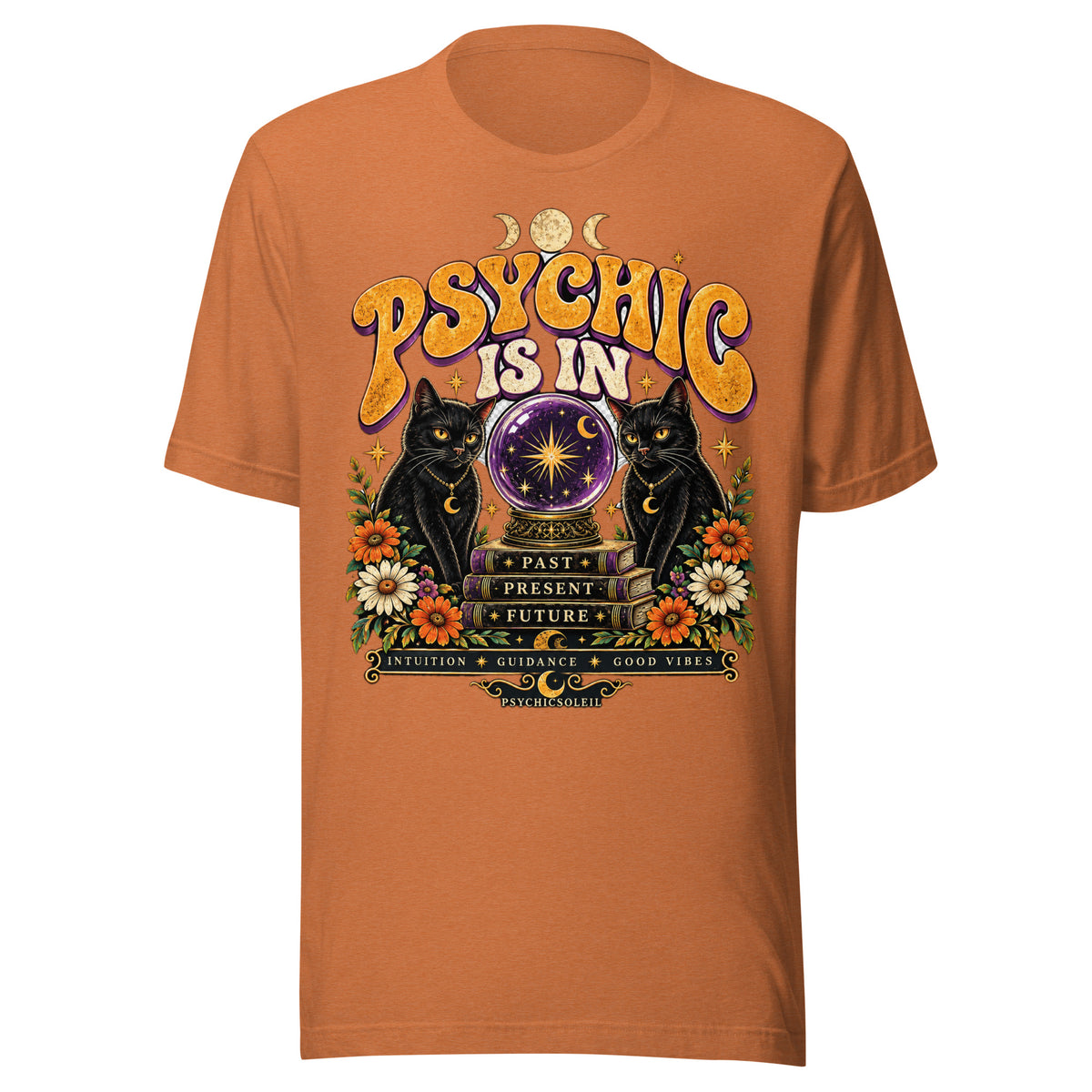 Retro Psychic Is In unisex t-shirt in heather autumn, front. Two black cats and a crystal ball on Past, Present, Future books, with daisies and moon phases.