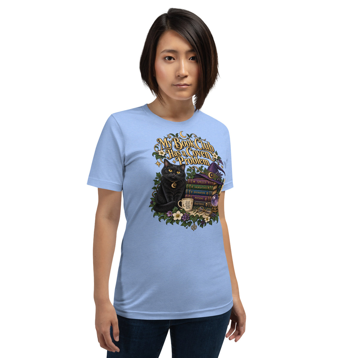 My Book Club Has A Coven Problem dark academia design, a witchy black cat and a stack of spellbooks, on a heather carolina blue unisex t-shirt, front view
