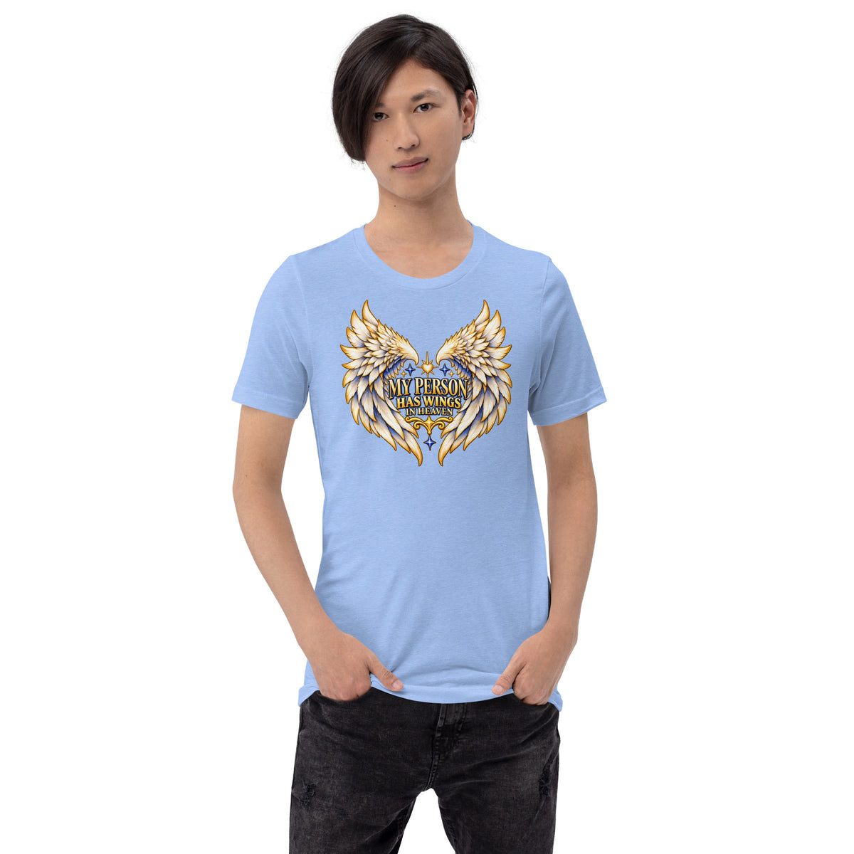 My Person Has Wings In Heaven design, gold and white angel wings curving into a heart around gold lettering with blue star sparkles, on a heather Carolina blue unisex t-shirt worn by a model, front view